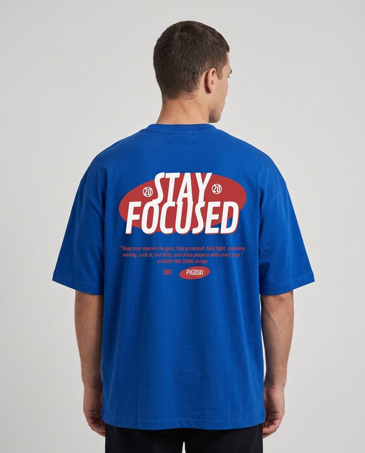 PIGOSKI Stay Focus Tee on model — studio fit shot (back print)